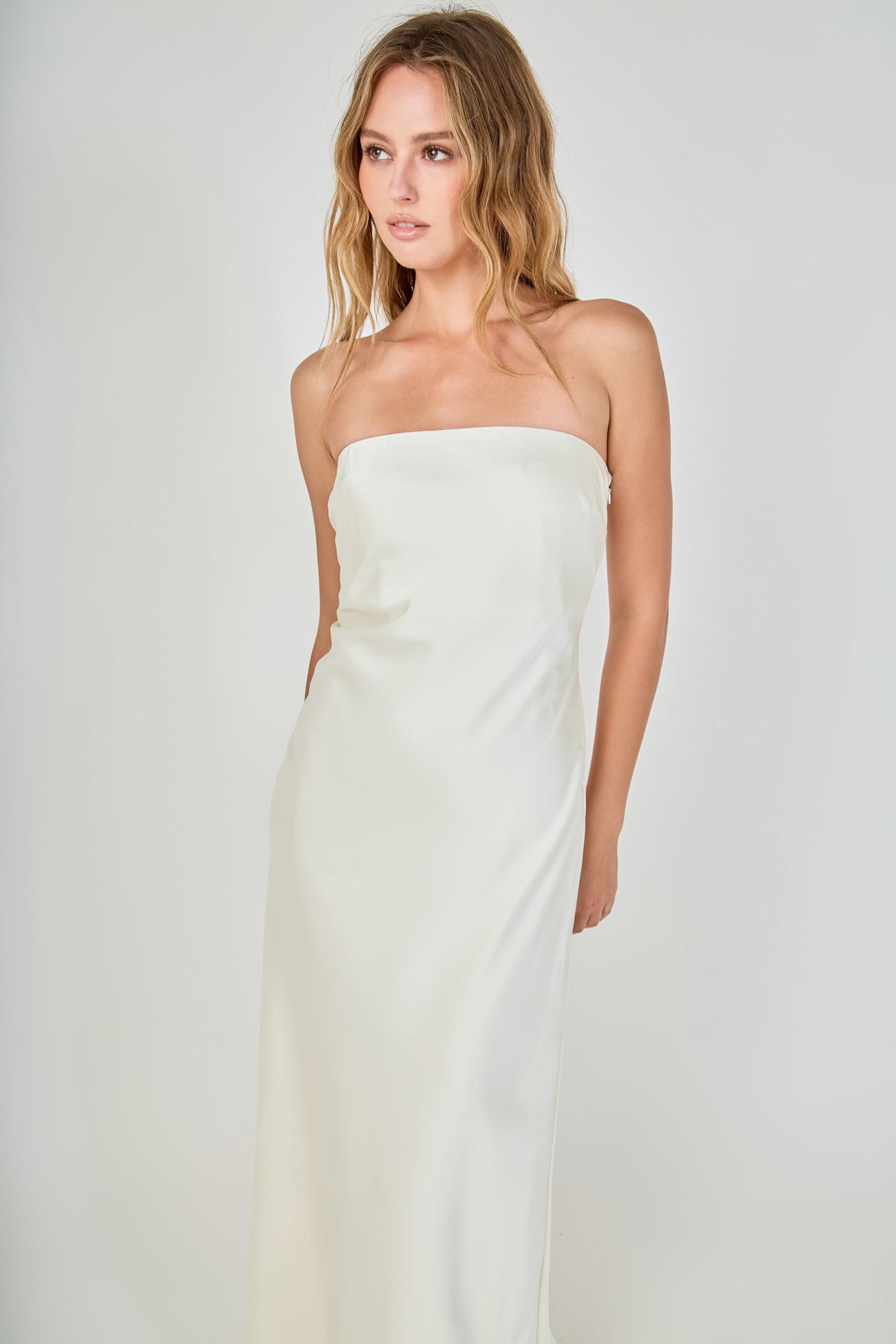 Face-forward posed view of an ivory strapless satin maxi dress featuring a clean straight neckline and fluid column silhouette.