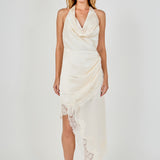 Full-length front view of a champagne satin halter dress with a draped cowl neckline, asymmetrical skirt drape, and eyelash lace trim.