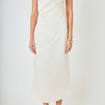 Upper bodice close-up view of a champagne satin wrap midi dress highlighting the draped wrap bust and side ruched seam.