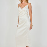 Side profile view of a champagne satin wrap midi dress displaying the slim-fitting drape and discreet side zipper detail.