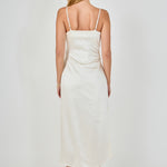 Straight-on rear view of a champagne satin wrap midi dress showing the slender adjustable shoulder straps and smooth back drape.