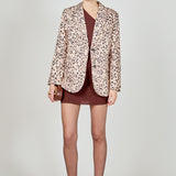 Beige multi leopard print woven oversized blazer featuring notched lapels, long sleeves with shoulder pads, front flap pockets, and a single-breasted button closure.