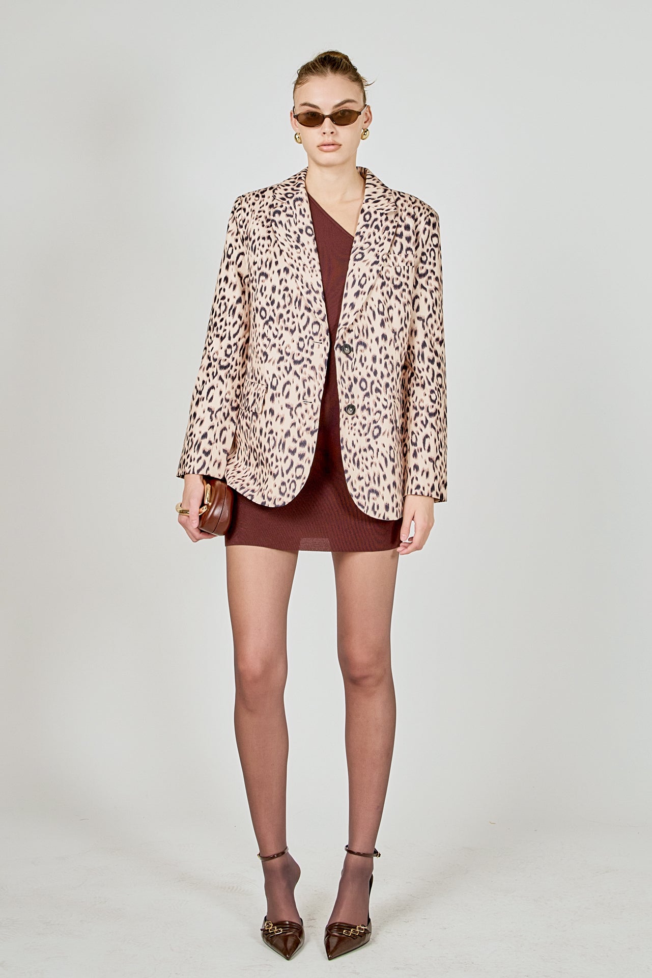 Beige multi leopard print woven oversized blazer featuring notched lapels, long sleeves with shoulder pads, front flap pockets, and a single-breasted button closure.