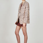 Beige multi leopard print woven oversized blazer featuring notched lapels, long sleeves with shoulder pads, front flap pockets, and a single-breasted button closure.