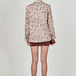 Beige multi leopard print woven oversized blazer featuring notched lapels, long sleeves with shoulder pads, front flap pockets, and a single-breasted button closure.