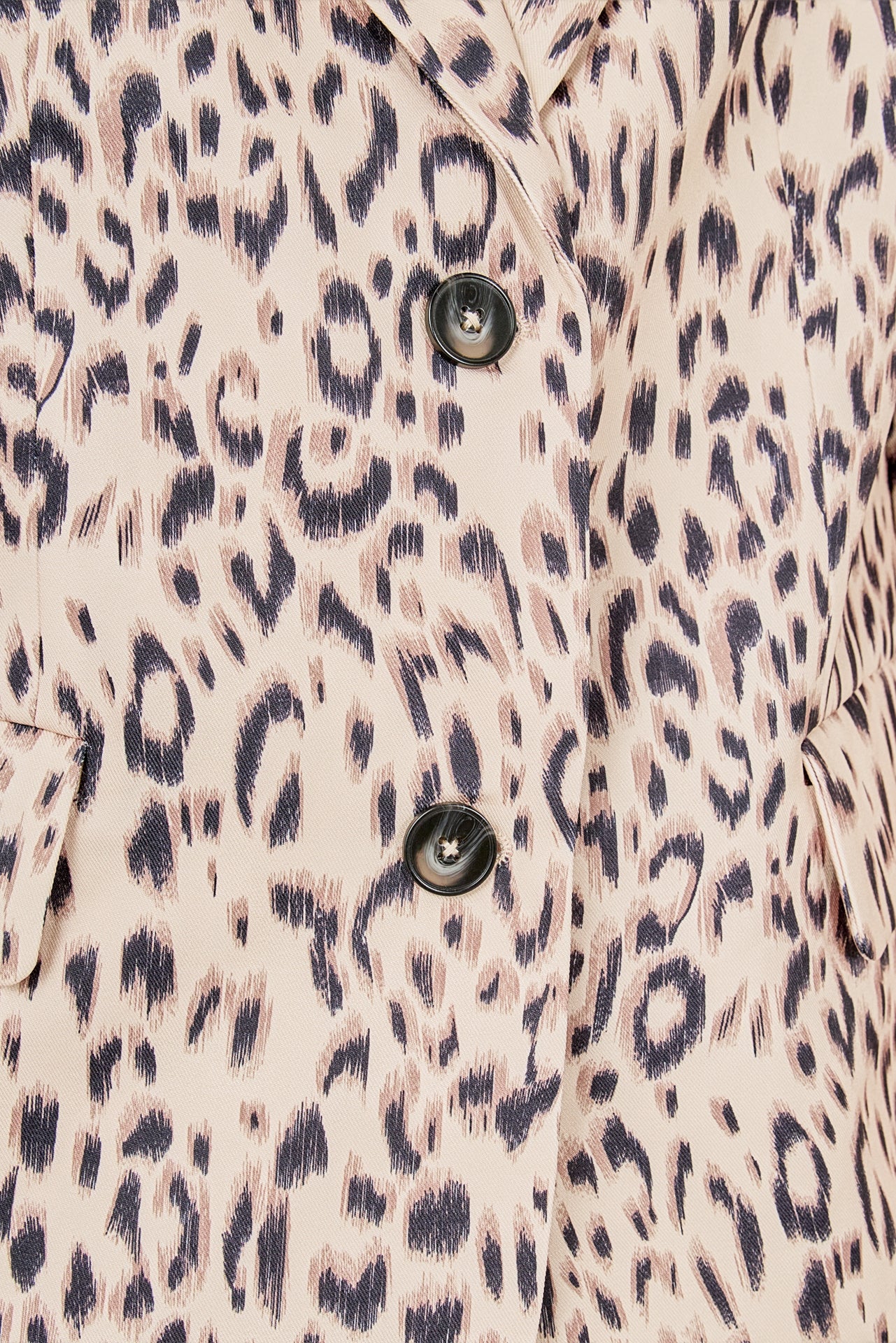 Beige multi leopard print woven oversized blazer featuring notched lapels, long sleeves with shoulder pads, front flap pockets, and a single-breasted button closure.