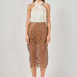 Full-length front view of an ivory satin top featuring a crossover halter neckline, styled with a brown laser-cut lace midi skirt.