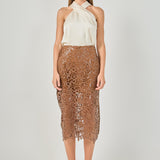 Full-length front view of an ivory satin top featuring a crossover halter neckline, styled with a brown laser-cut lace midi skirt.
