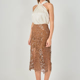 Side profile view of an ivory satin crossover halter top showing the sleeveless drape and fluid silhouette.