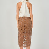 Straight-on rear view of an ivory satin halter top displaying the high collar closure and open back design.