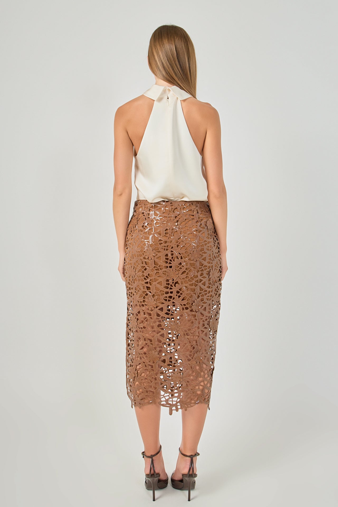 Straight-on rear view of an ivory satin halter top displaying the high collar closure and open back design.