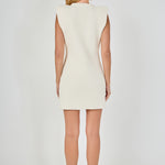 Straight-on rear view of a cream sleeveless knit mini dress showing the clean back profile and wide cap shoulder design.