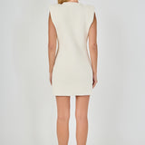 Straight-on rear view of a cream sleeveless knit mini dress showing the clean back profile and wide cap shoulder design.