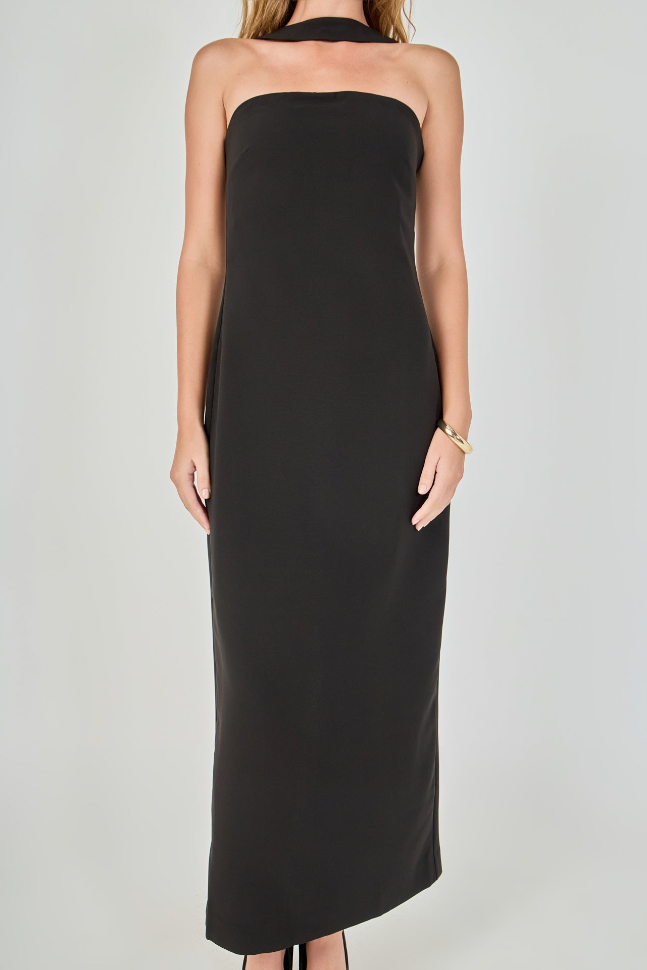 Close-up view of a black strapless maxi dress highlighting the straight strapless neckline, smooth bodice, and matching fabric choker collar.