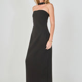 Side view of a black strapless column maxi dress featuring a slim fitted silhouette and matching neckband detail.