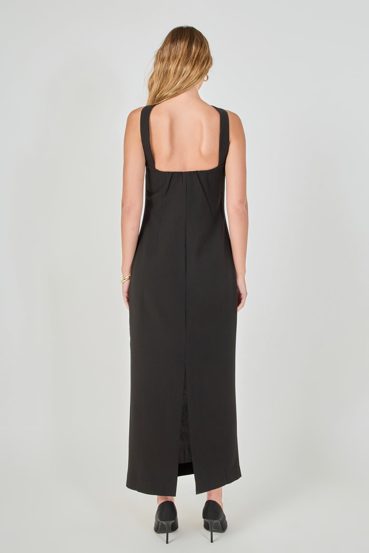 Back view of a black strapless column maxi dress showing the back choker neckband, low back cut, and long straight hemline.