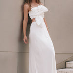 Three-quarter view of an ivory satin slip maxi skirt highlighting the high waistband and smooth, body-skimming fit.