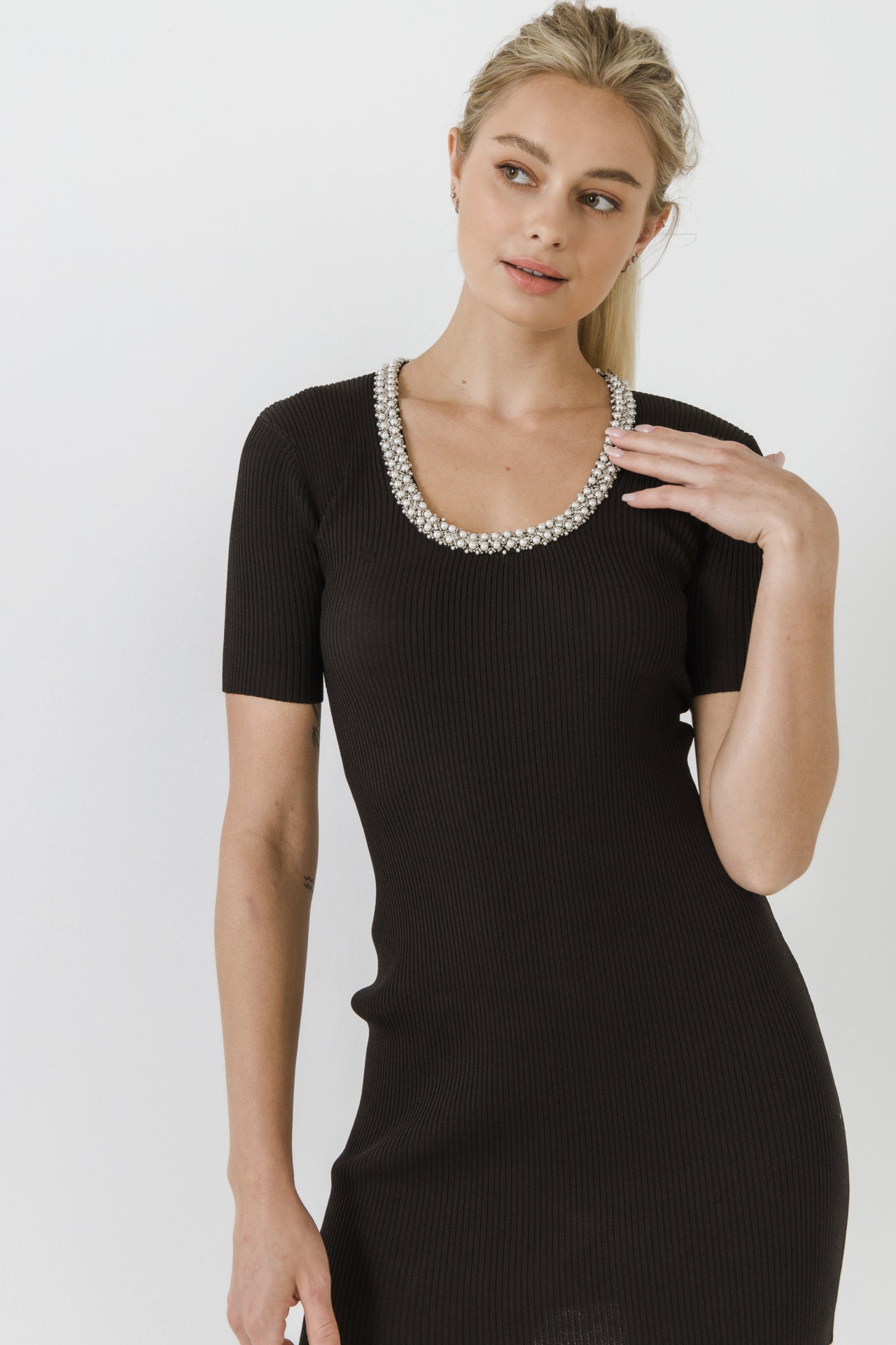 Black dress shop with pearl neckline